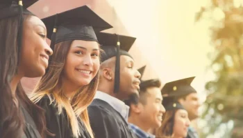 Graduation_StudentsGroup_Smiling_Outdoor_GettyImages-907837926
